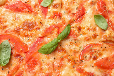 Photo of Delicious pizza Margherita as background, closeup view