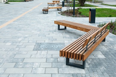 Paved city street with comfortable wooden benches