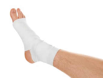 Man with foot wrapped in medical bandage on white background, closeup