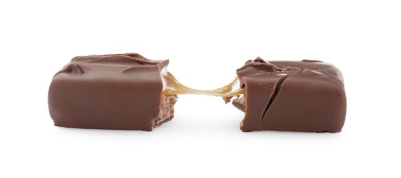 Photo of Pieces of chocolate bar with caramel on white background