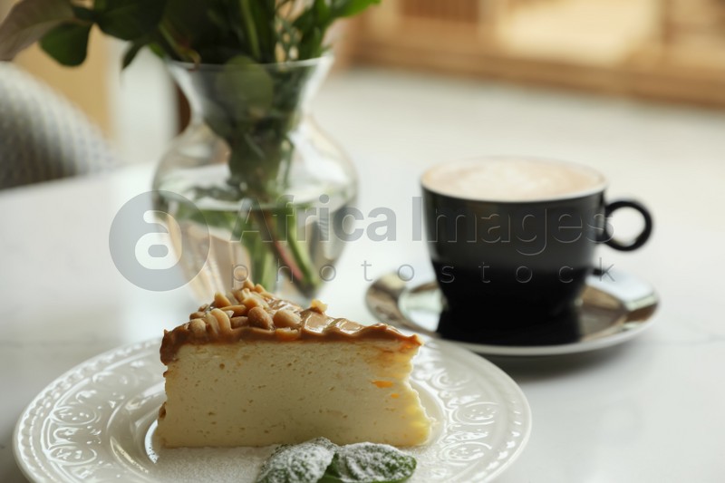 Tasty dessert and cup of fresh coffee on table indoors