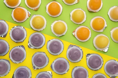 Tasty bright jelly cups on color background, flat lay