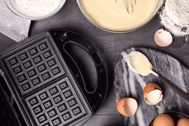 Photo of Flat lay composition with ingredients for cooking Belgian waffles on grey table