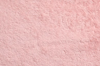 Soft pink towel as background, top view