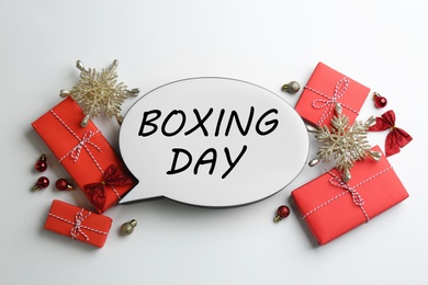 Speech bubble with phrase BOXING DAY and Christmas decorations on white background, flat lay