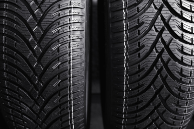 Car tires as background, closeup. Auto store