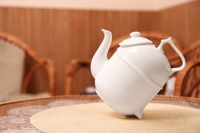 White teapot for traditional ceremony on table
