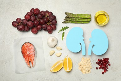 Paper cutout of kidneys and different healthy products on light grey table, flat lay