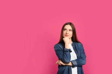 Pensive woman on pink background, space for text. Thinking about answer to question