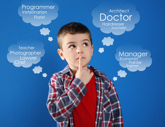 Thoughtful little boy choosing profession on blue background