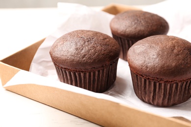 Photo of Delicious fresh chocolate cupcakes on table, closeup