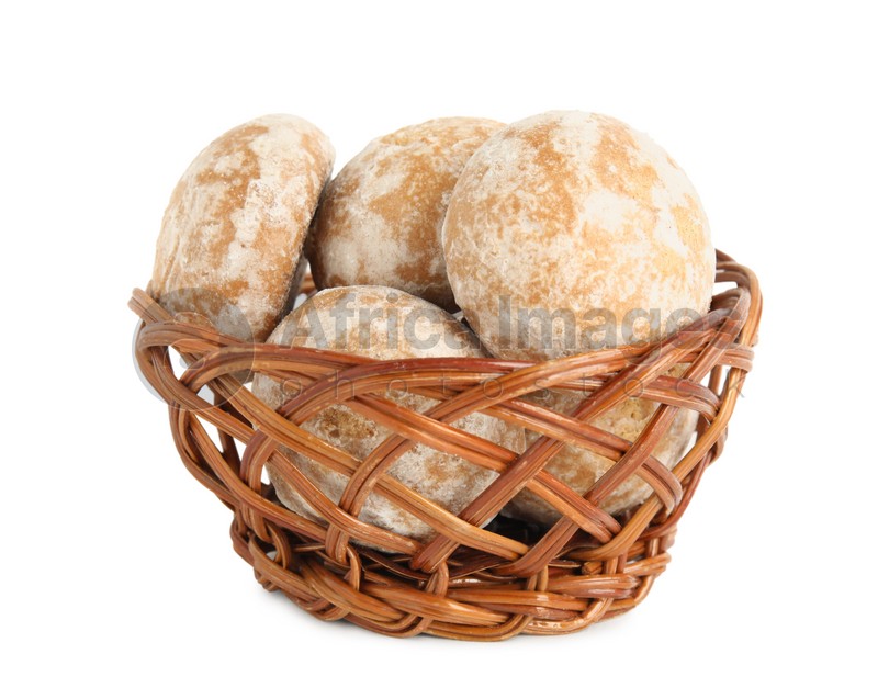 Photo of Tasty homemade gingerbread cookies in wicker basket on white background
