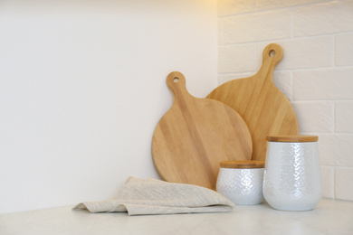 Wooden boards, napkin and kitchen items on countertop indoors