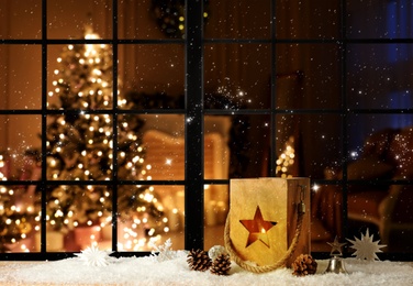 Beautiful composition with wooden Christmas lantern near window