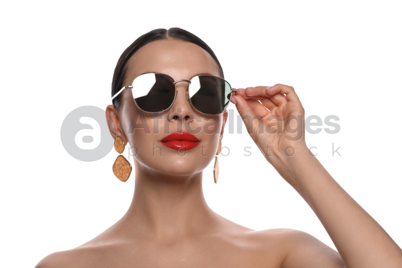 Attractive woman wearing fashionable sunglasses on white background
