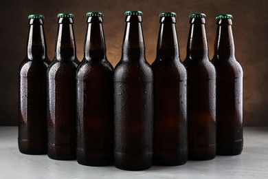 Photo of Many bottles of beer on white table