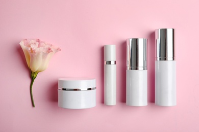 Photo of Set of luxury cosmetic products on pink background, flat lay