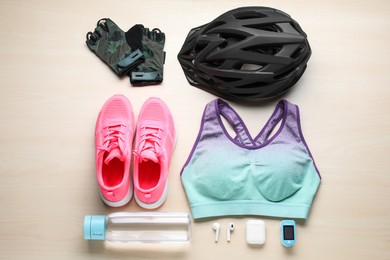 Flat lay composition with different cycling accessories on wooden background