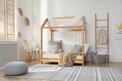 Stylish child room interior with house bed