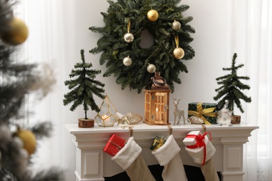 Fireplace in room with Christmas decorations. Interior design