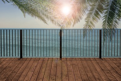 Image of Outdoor wooden terrace under palm trees revealing picturesque view on ocean in morning