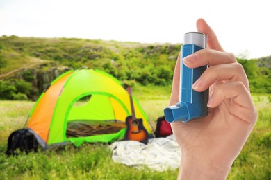 Image of Young woman using asthma inhaler outside on sunny day, closeup. Emergency first aid during outdoor recreation