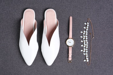 Photo of Pair of female shoes and accessories on gray background, top view