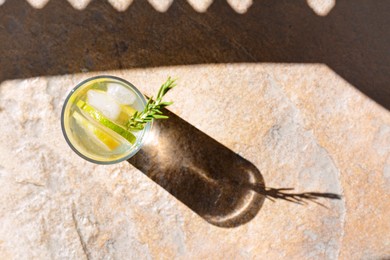 Photo of Summer refreshing lemonade on light brown table, top view. Space for text