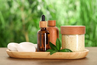 Spa gift set with different products on wooden table against blurred background