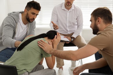 Group of drug addicted people at therapy session indoors