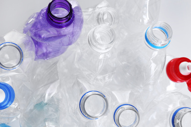 Many crumpled bottles as background, closeup. Plastic recycling