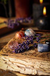 Gemstones and healing herbs on wooden board