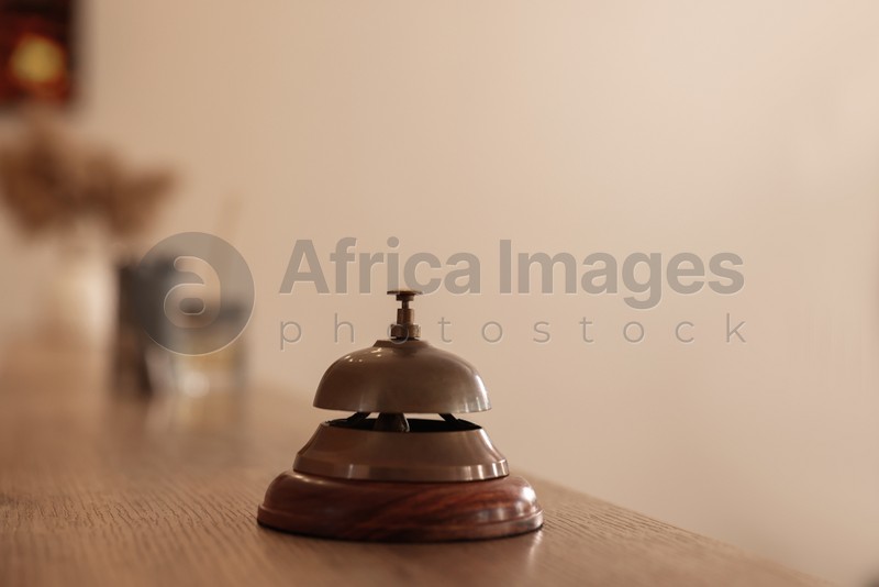Photo of Hotel service bell on wooden reception desk