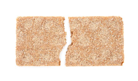 Halves of crunchy rye crispbread on white background, top view