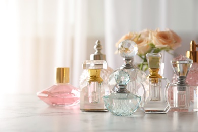 Many different perfume bottles on dressing table, space for text
