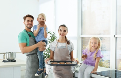 Happy family with homemade oven baked cookies in kitchen