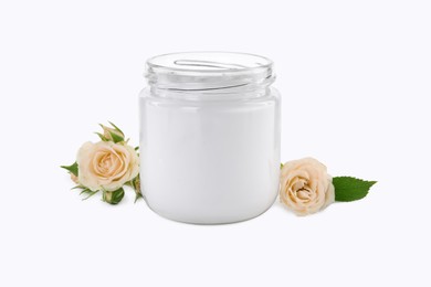 Jar of hand cream and roses on white background