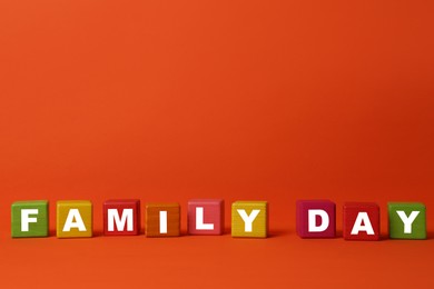 Photo of Colorful cubes with text Family Day on orange background