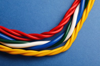 Many electrical cables on blue background, closeup