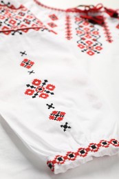 Beautiful white shirt with red Ukrainian national embroidery, closeup