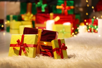 Beautiful Christmas gifts on furry carpet in room