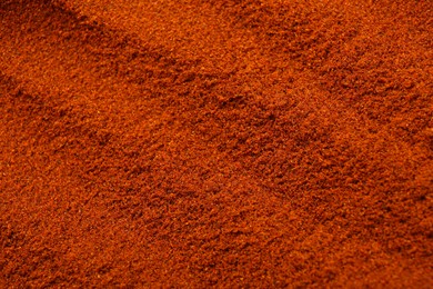 Photo of Aromatic paprika powder as background, top view