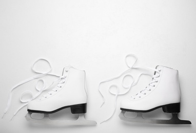 Pair of ice skates on white background, top view. Space for text