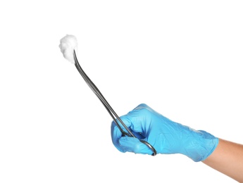 Doctor in sterile glove holding medical clamp with cotton ball on white background
