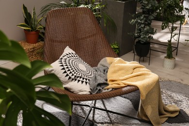 Lounge area interior with comfortable armchair and beautiful houseplants
