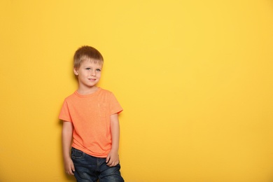 Portrait of cute little boy against color background with space for text