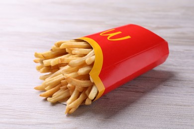 MYKOLAIV, UKRAINE - AUGUST 12, 2021: Big portion of McDonald's French fries on white wooden table