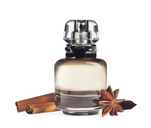 Photo of Bottle of perfume and different spices on white background