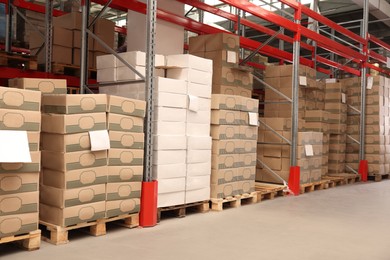 Warehouse with stacks of boxes on wooden pallets. Wholesaling