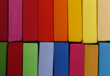 Set of colorful pastels as background, closeup. Drawing materials